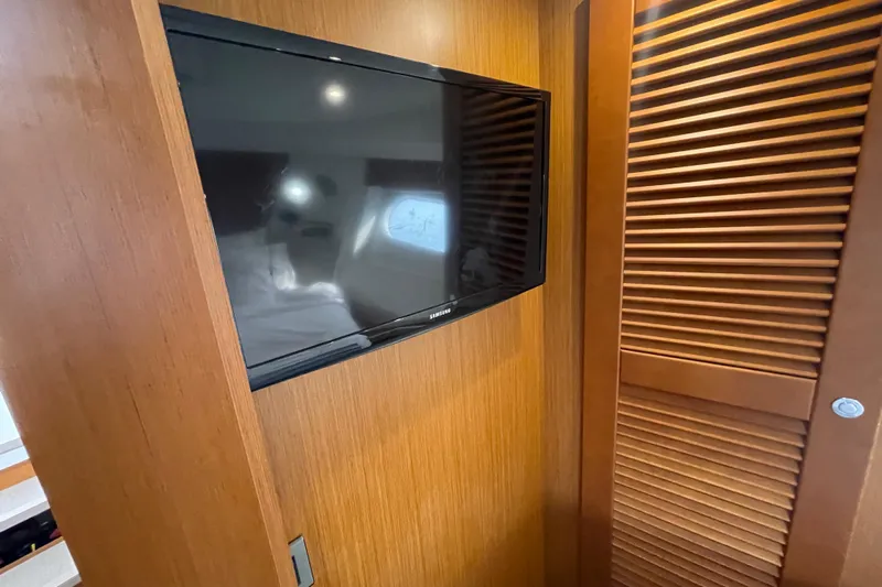 A To Z Yacht Photos Pics 2018 Beneteau Swift Trawler 35 interior with mounted TV and wooden paneling.