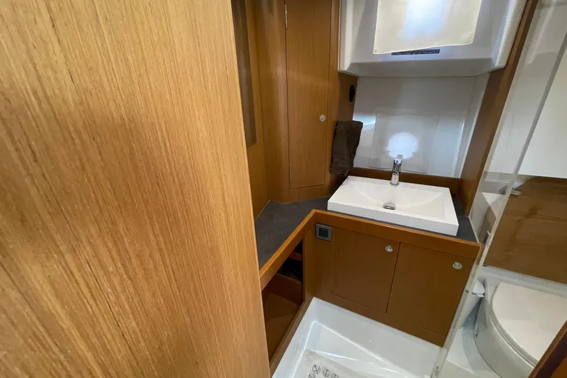 A To Z Yacht Photos Pics 2018 Beneteau Swift Trawler 35 bathroom with wooden cabinetry and modern sink.