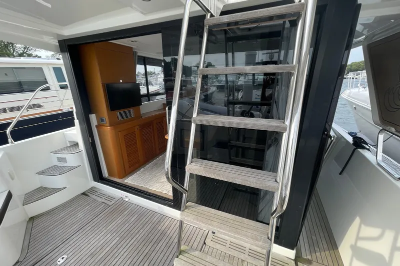 A To Z Yacht Photos Pics 2018 Beneteau Swift Trawler 35 interior with stairs and wooden cabinetry.