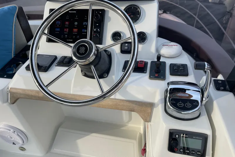 A To Z Yacht Photos Pics 2018 Beneteau Swift Trawler 35 helm with steering wheel and navigation controls.