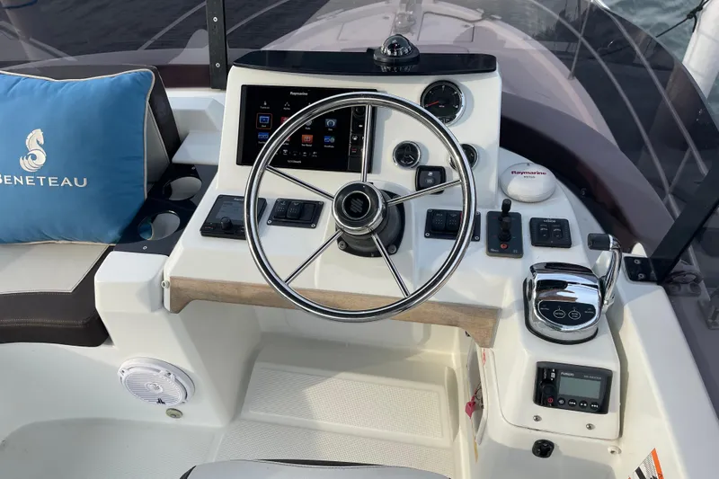 A To Z Yacht Photos Pics Helm of 2018 Beneteau Swift Trawler 35 with steering wheel and navigation controls.