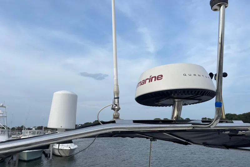 A To Z Yacht Photos Pics Radar equipment on a 2018 Beneteau Swift Trawler 35 against a cloudy sky.