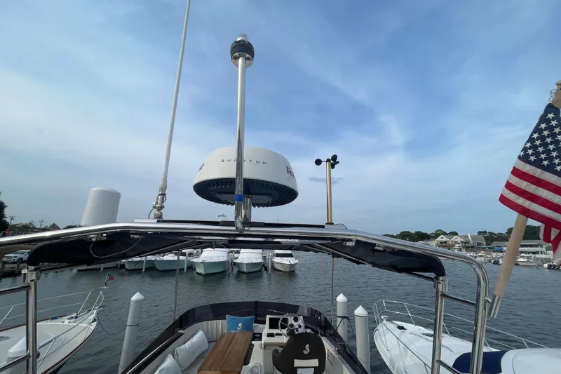 A To Z Yacht Photos Pics 2018 Beneteau Swift Trawler 35 at marina, featuring radar and American flag.
