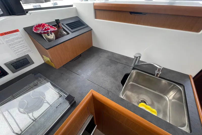 A To Z Yacht Photos Pics 2018 Beneteau Swift Trawler 35 kitchen area with sink and countertop.