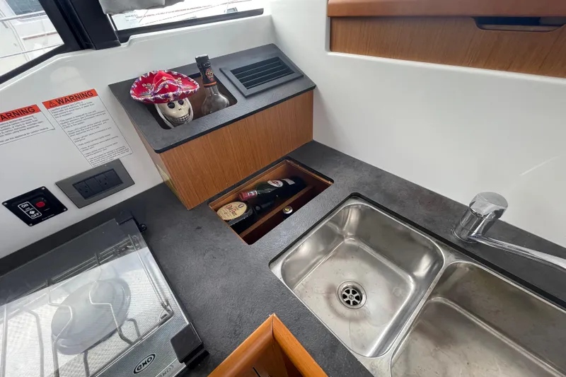 A To Z Yacht Photos Pics 2018 Beneteau Swift Trawler 35 kitchen with sink, stove, and storage.