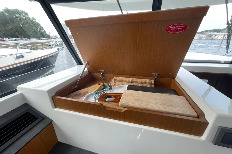 A To Z Yacht Photos Pics 2018 Beneteau Swift Trawler 35 interior with open wooden storage compartment.