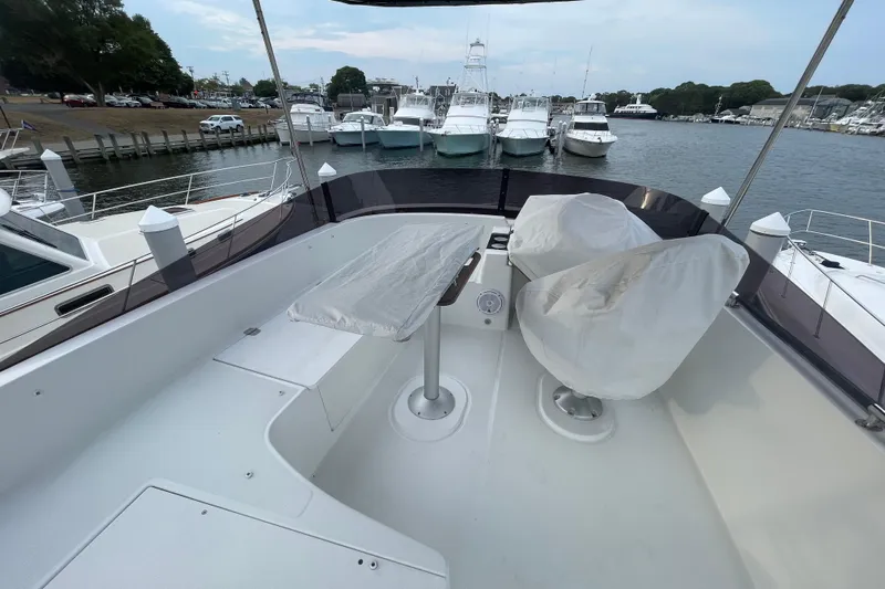 A To Z Yacht Photos Pics Flybridge of 2018 Beneteau Swift Trawler 35, featuring covered seating and table, docked at marina.