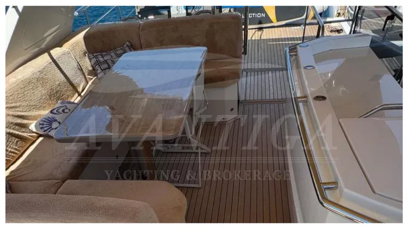  Yacht Photos Pics Luxurious seating area on 2016 Absolute 64 FLY yacht with elegant table and cushions.