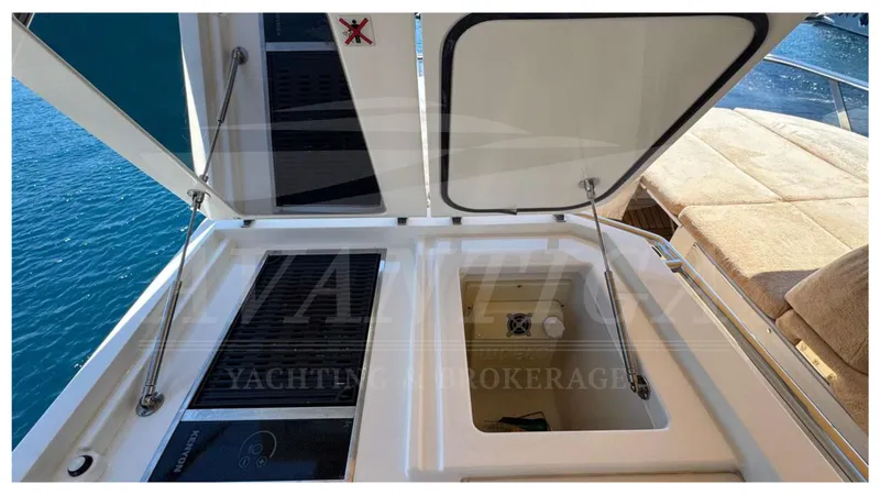  Yacht Photos Pics Open storage compartments on 2016 Absolute 64 FLY yacht deck, overlooking blue water.