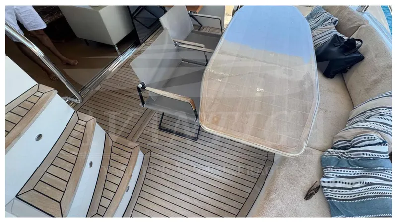  Yacht Photos Pics Luxurious Absolute 64 FLY yacht deck with seating, table, and striped cushions, 2016 model.