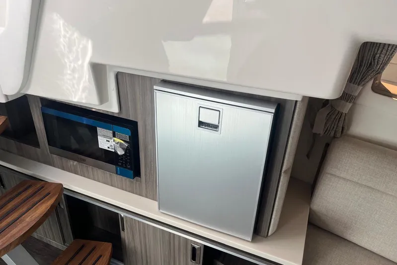  Yacht Photos Pics Interior of 2026 Sea Ray Sundancer 320 Outboard with microwave and compact fridge.