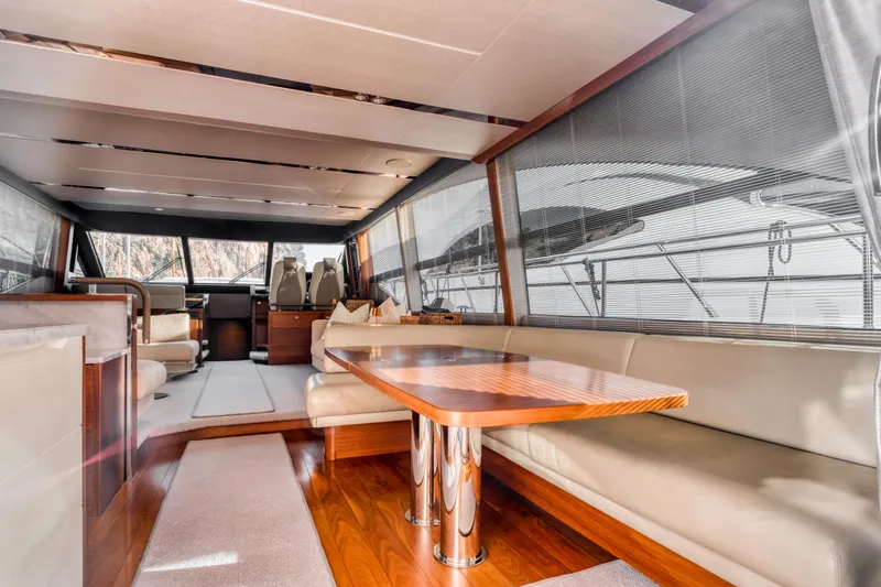  Yacht Photos Pics Luxurious interior of a 2016 Princess 68 yacht with elegant seating and wooden table.
