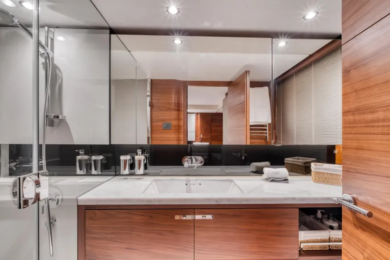  Yacht Photos Pics Luxurious bathroom interior on a 2016 Princess 68 yacht, featuring modern fixtures and wooden accents.