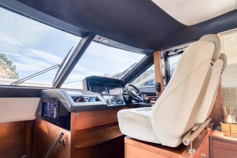  Yacht Photos Pics Luxurious interior of 2016 Princess 68 yacht cockpit with modern controls and comfortable seating.