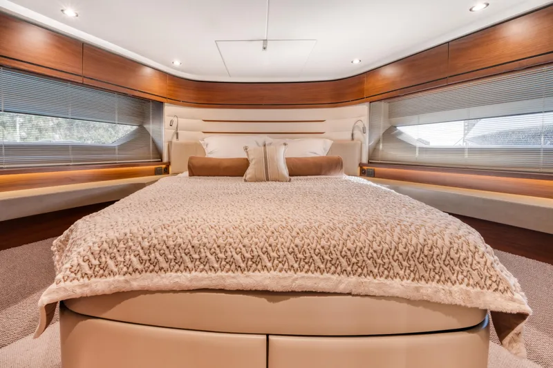  Yacht Photos Pics Luxurious bedroom interior of 2016 Princess 68 yacht with elegant bedding and wood accents.
