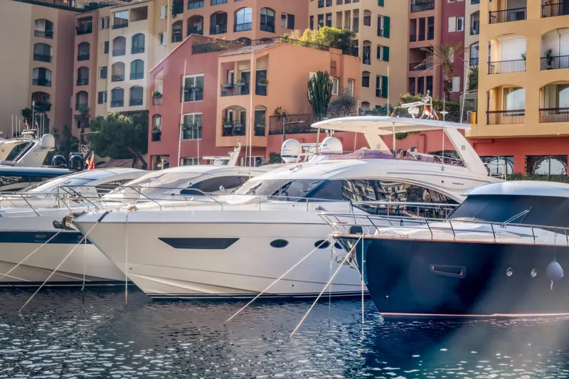  Yacht Photos Pics Luxury yachts docked in a marina, featuring a 2016 Princess 68 model.