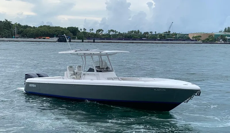  Yacht Photos Pics 2012 Intrepid 327 Center Console boat on the water with a scenic background.