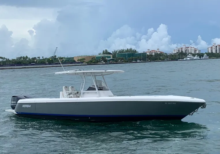  Yacht Photos Pics 2012 Intrepid 327 Center Console boat on the water with a cloudy sky background.
