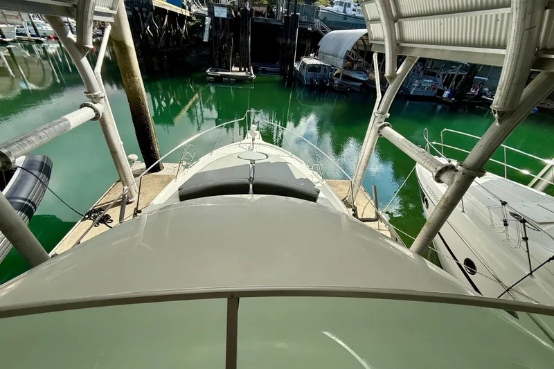 Pier Pressure Yacht Photos Pics 1999 Bayliner 3788 Command Bridge Motoryacht docked in a marina, viewed from above.