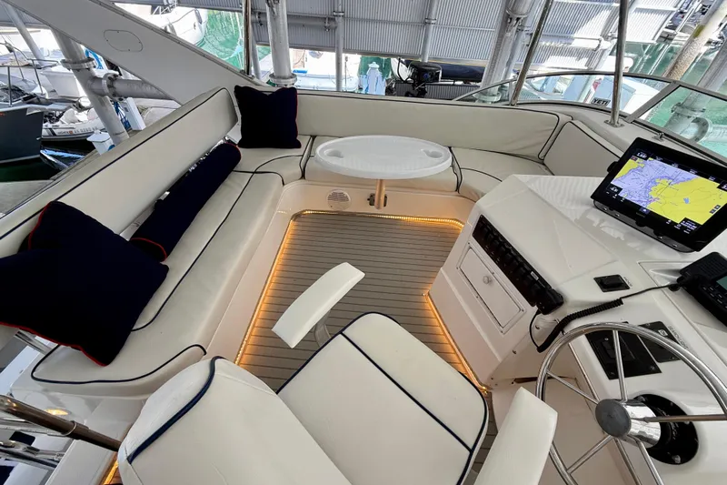 Pier Pressure Yacht Photos Pics 1999 Bayliner 3788 Command Bridge Motoryacht interior with seating, table, and navigation equipment.