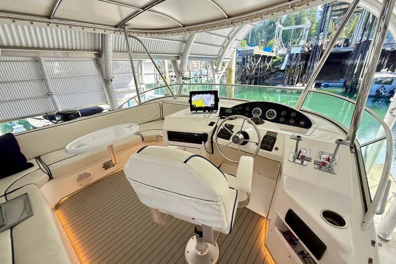 Pier Pressure Yacht Photos Pics 1999 Bayliner 3788 Command Bridge Motoryacht interior with helm, seating, and navigation equipment.
