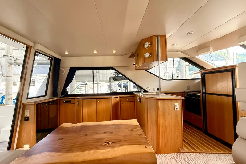 Pier Pressure Yacht Photos Pics 1999 Bayliner 3788 Command Bridge Motoryacht interior with wooden cabinetry and modern design.