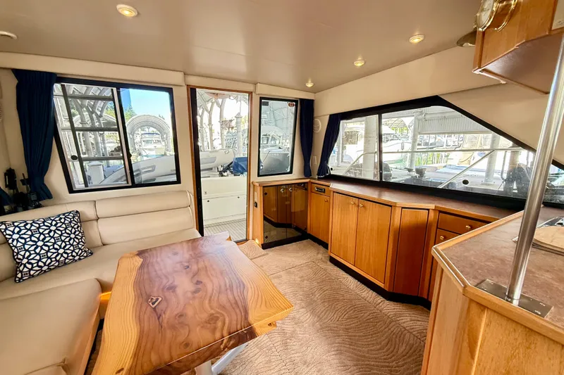 Pier Pressure Yacht Photos Pics 1999 Bayliner 3788 Command Bridge Motoryacht interior with wood cabinetry and seating area.