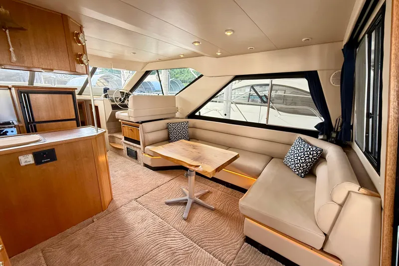 Pier Pressure Yacht Photos Pics 1999 Bayliner 3788 Command Bridge Motoryacht interior with plush seating and wooden accents.