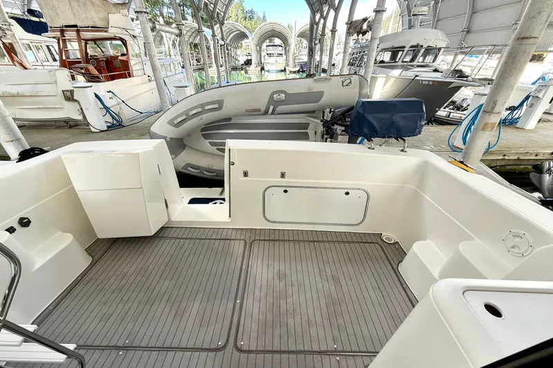 Pier Pressure Yacht Photos Pics 1999 Bayliner 3788 Command Bridge Motoryacht cockpit with docked inflatable boat.