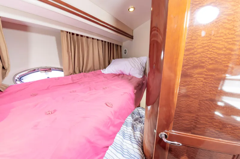 Spring Break Yacht Photos Pics 2004 Carver 56 Voyager SE bedroom with pink bedding and wooden door
