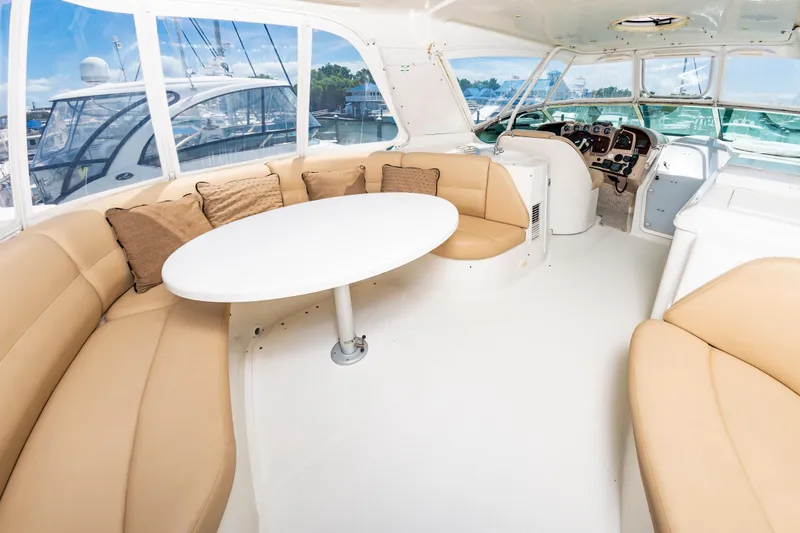 Spring Break Yacht Photos Pics 2004 Carver 56 Voyager SE yacht interior with beige seating and round table.