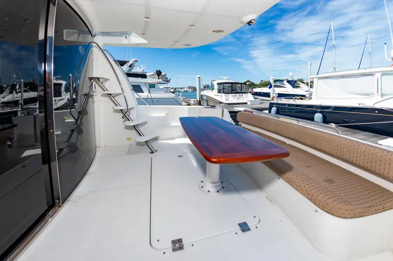 Spring Break Yacht Photos Pics Outdoor seating area on a 2004 Carver 56 Voyager SE yacht at a marina.