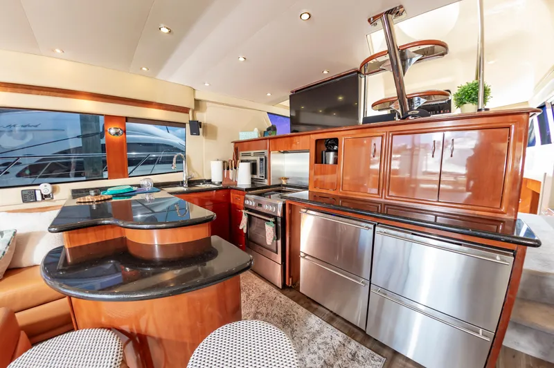 Spring Break Yacht Photos Pics Luxurious kitchen interior of 2004 Carver 56 Voyager SE yacht with modern appliances.