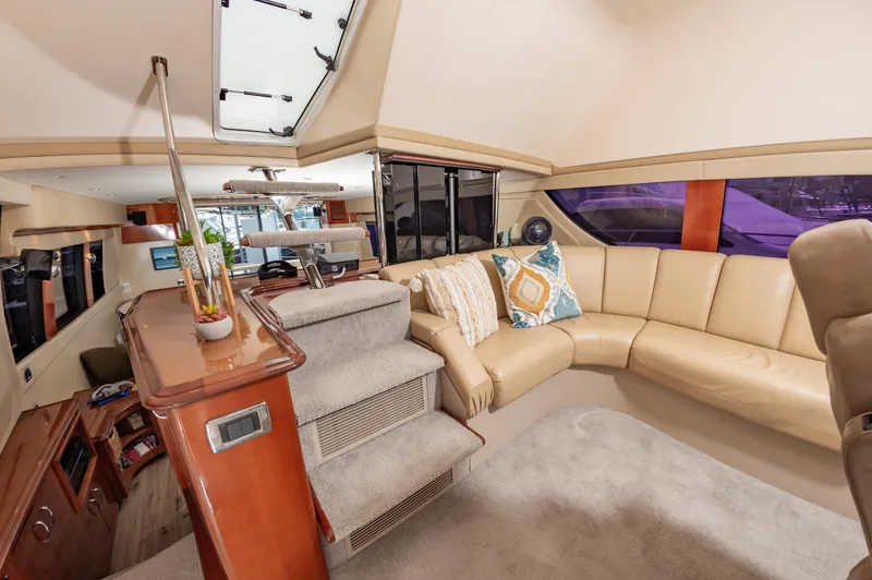 Spring Break Yacht Photos Pics Luxurious interior of 2004 Carver 56 Voyager SE yacht with beige leather seating.