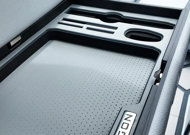  Yacht Photos Pics 2025 Nautique G23 Paragon interior storage compartment with sleek design and cup holders.