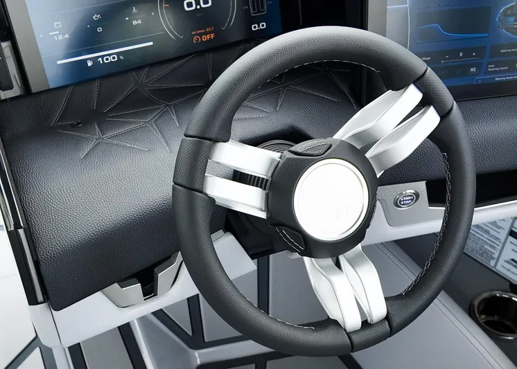  Yacht Photos Pics Steering wheel of 2025 Nautique G23 Paragon boat with modern dashboard display.
