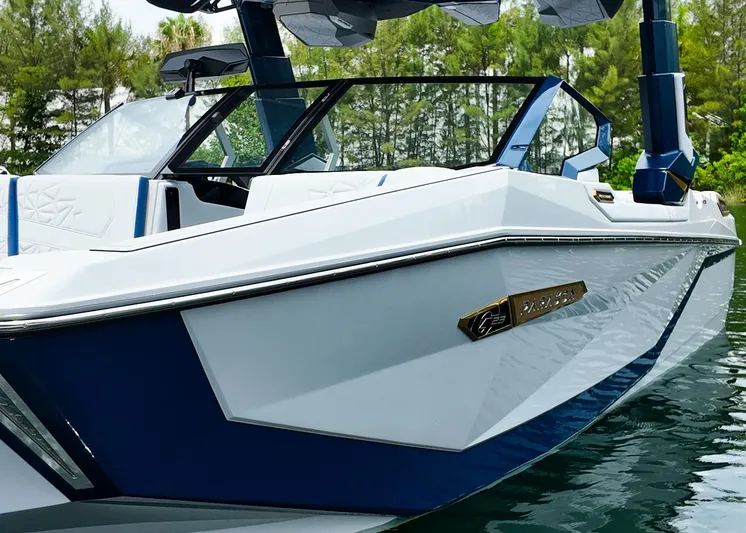  Yacht Photos Pics 2025 Nautique G23 Paragon boat on water, sleek design, blue and white color scheme.
