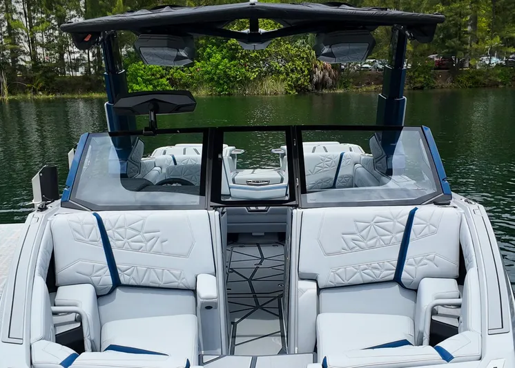  Yacht Photos Pics 2025 Nautique G23 Paragon boat interior with luxurious seating and modern design on a serene lake.