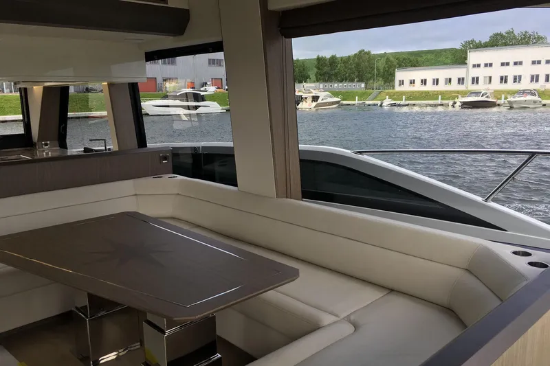  Yacht Photos Pics Luxurious interior of 2018 Galeon 640 Fly yacht with elegant seating and table.