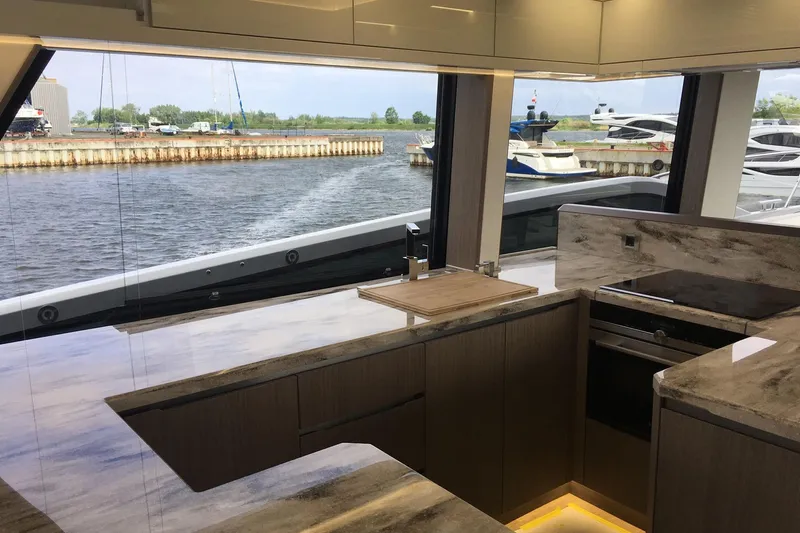  Yacht Photos Pics Luxurious kitchen interior of 2018 Galeon 640 Fly yacht with marina view.
