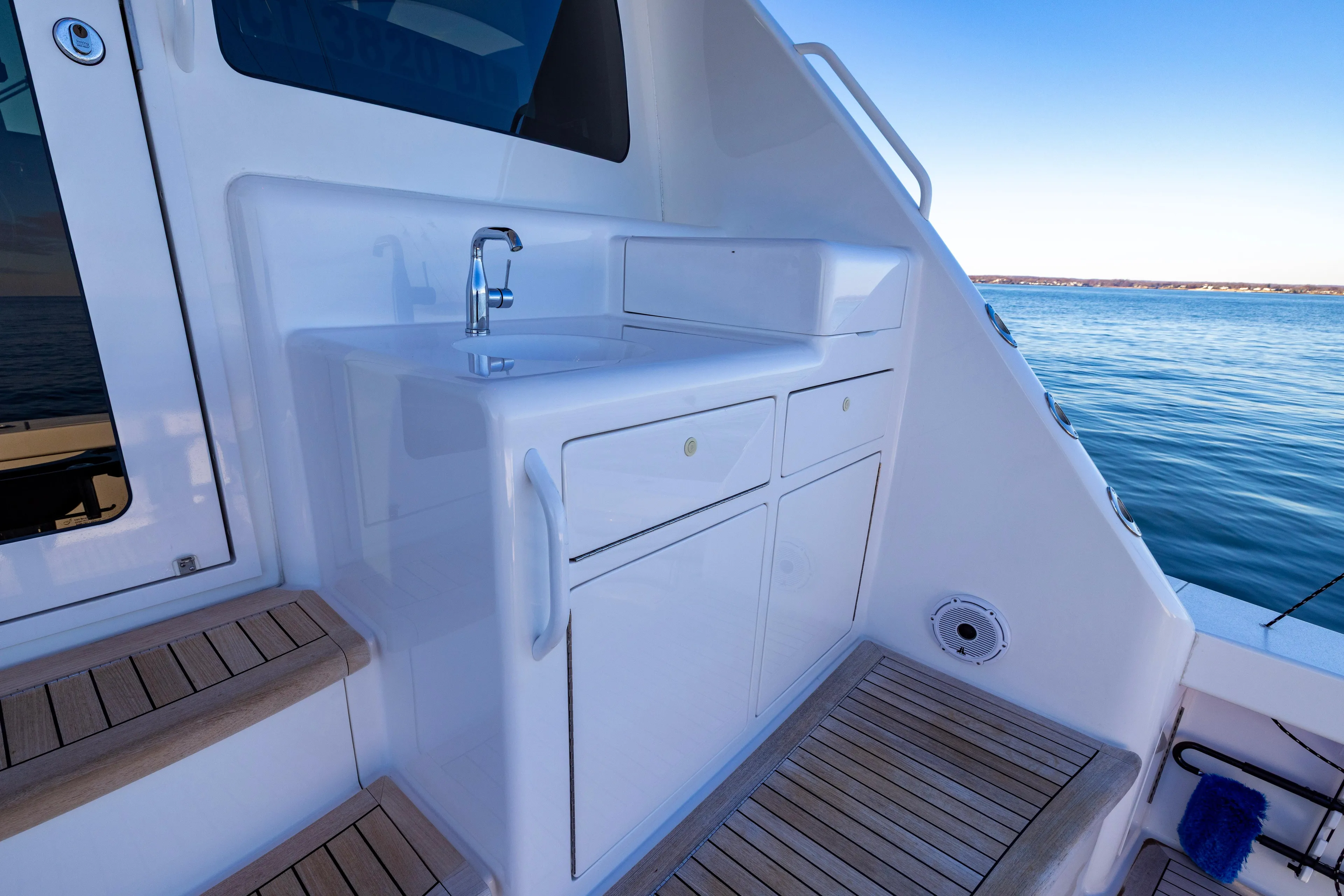What A Country Yacht Photos Pics 2022 Viking 54 Sport Coupe yacht with outdoor sink and ocean view.