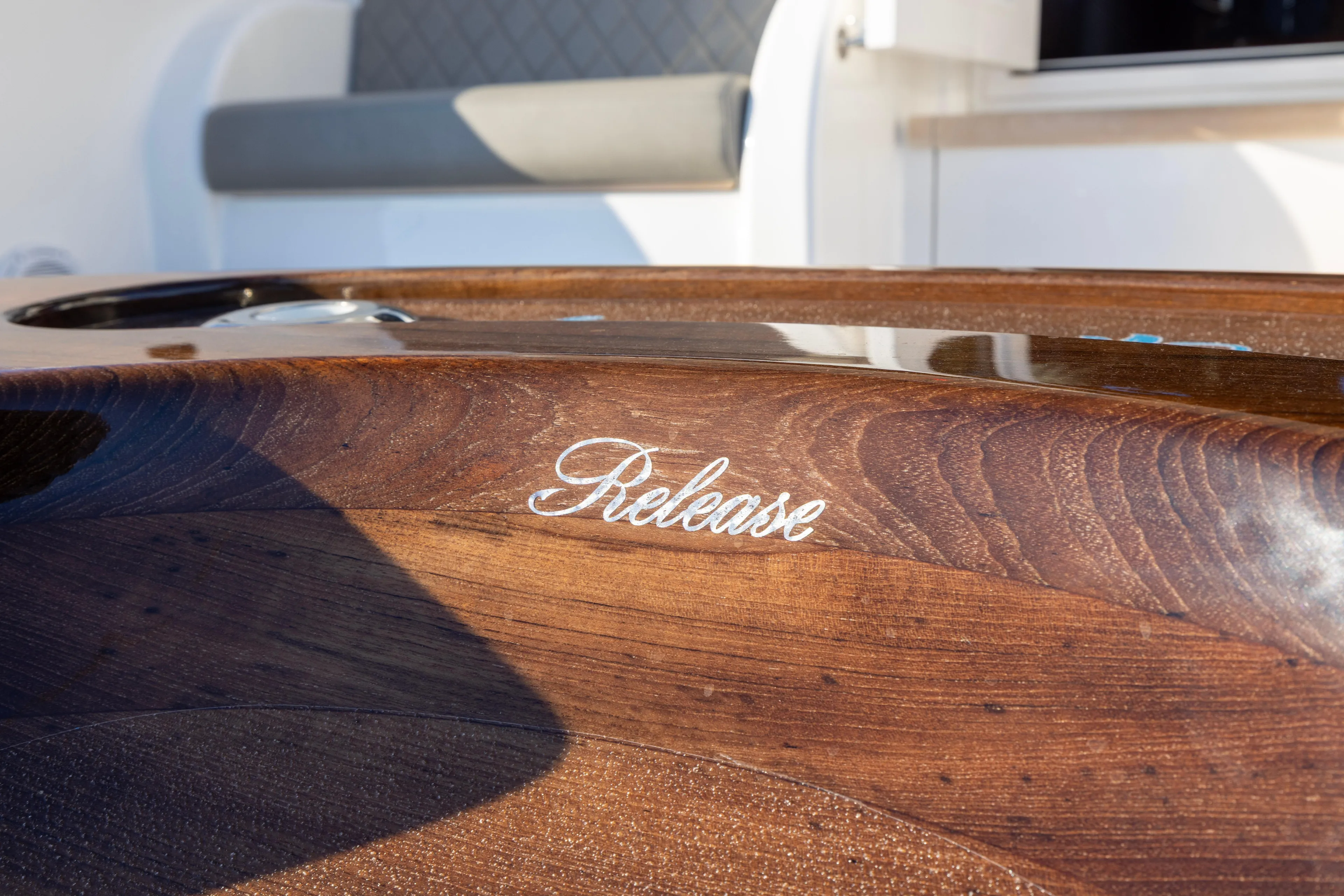 What A Country Yacht Photos Pics Polished wood detail on 2022 Viking 54 Sport Coupe yacht, featuring "Release" inscription.