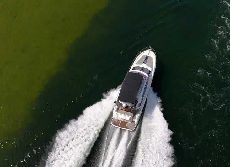 Kedem Plus Yacht Photos Pics Aerial view of 2021 Beneteau Monte Carlo 52 yacht cruising on water.
