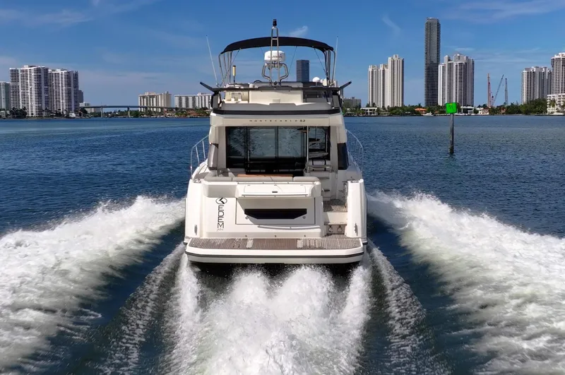 Kedem Plus Yacht Photos Pics 2021 Beneteau Monte Carlo 52 yacht cruising in urban waterfront setting.