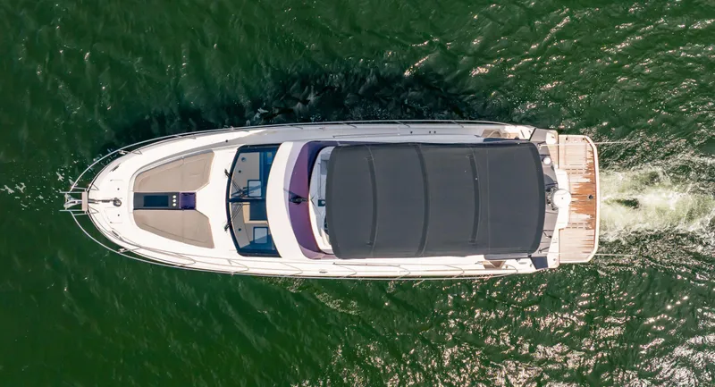 Kedem Plus Yacht Photos Pics Overhead view of 2021 Beneteau Monte Carlo 52 yacht cruising on green water.