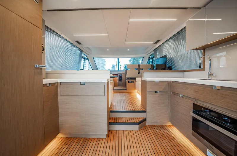 Kedem Plus Yacht Photos Pics Luxurious interior of 2021 Beneteau Monte Carlo 52 yacht with modern kitchen and sleek design.