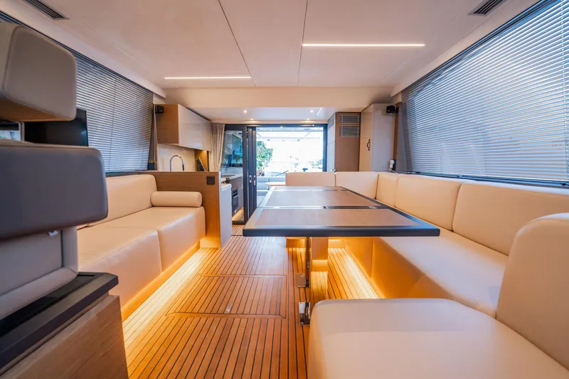 Kedem Plus Yacht Photos Pics Luxurious interior of 2021 Beneteau Monte Carlo 52 yacht with modern seating and ambient lighting.