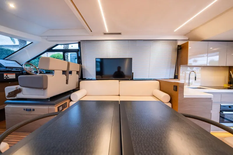 Kedem Plus Yacht Photos Pics Luxurious interior of 2021 Beneteau Monte Carlo 52 yacht with modern seating and kitchen.