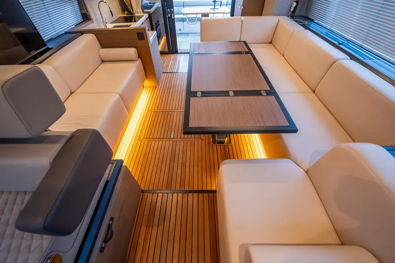Kedem Plus Yacht Photos Pics Luxurious interior of 2021 Beneteau Monte Carlo 52 yacht with elegant seating and ambient lighting.