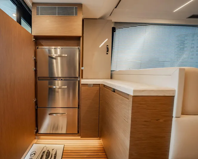 Kedem Plus Yacht Photos Pics Modern kitchen interior of 2021 Beneteau Monte Carlo 52 yacht with stainless steel appliances.